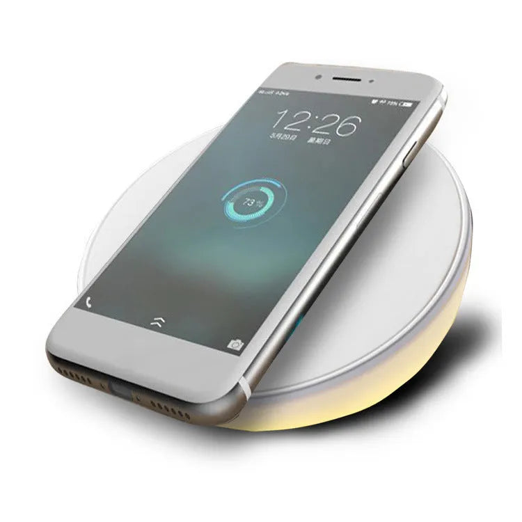 White wireless phone charger with digital clock display and three control buttons on the front.