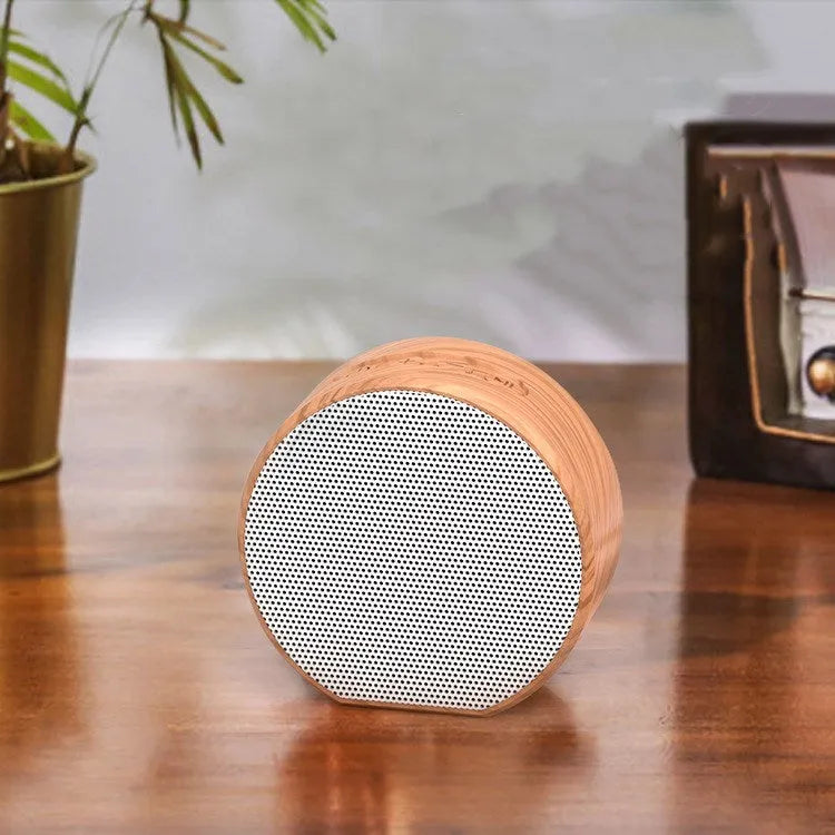 White wood grain Bluetooth speaker on a desk