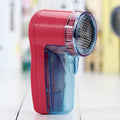 Blue portable electric lint remover for clothing with compact 11x16x9.5cm design