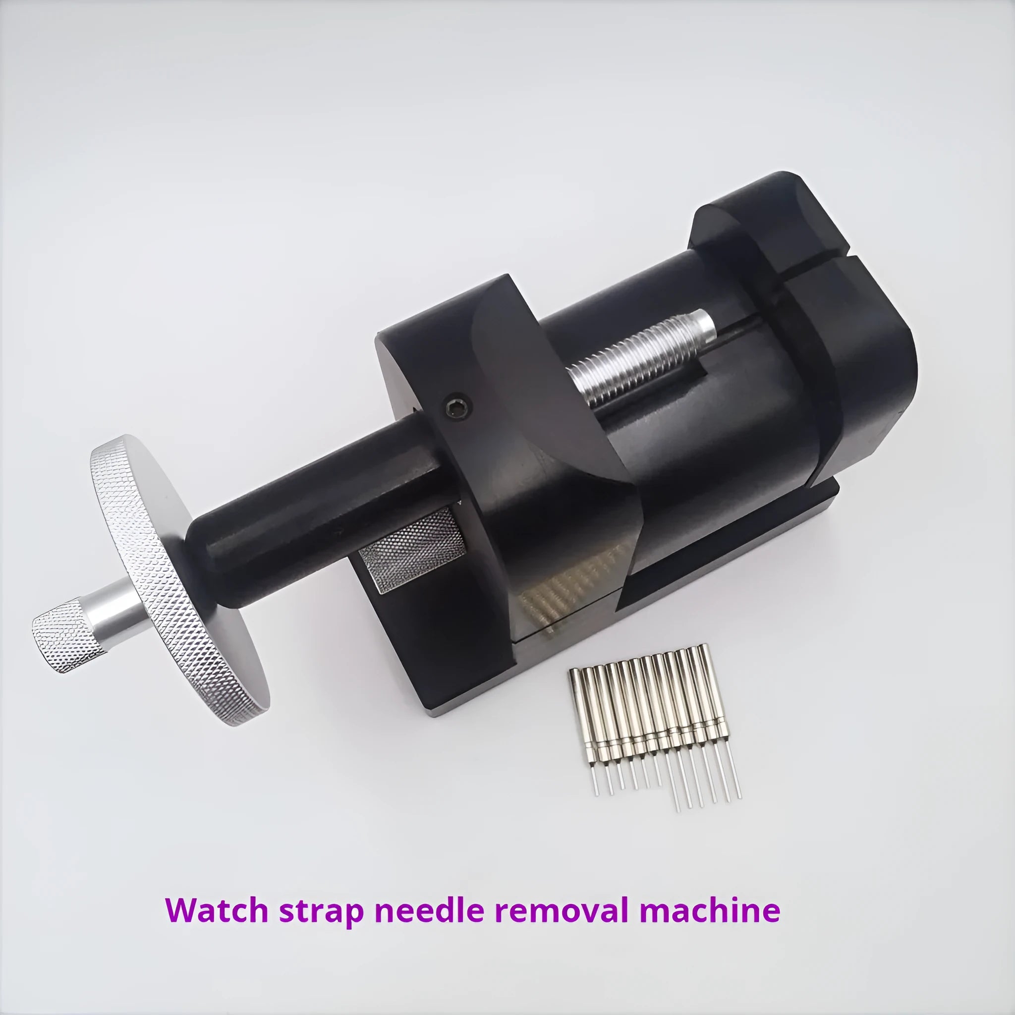 Steel alloy watch bracelet pin removal tool machine on a workshop bench.
