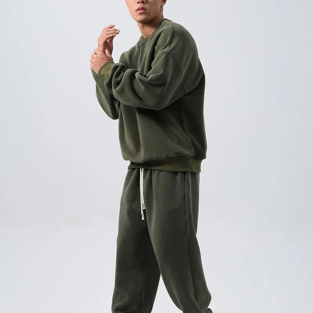 Men's polar fleece tracksuit set showing crew neck top with padded trousers in winter sportswear style