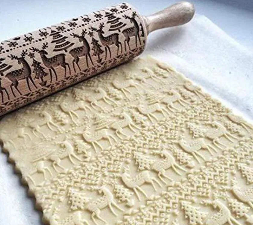 Wooden rolling pin with embossed Christmas pattern, measuring 45cm long.