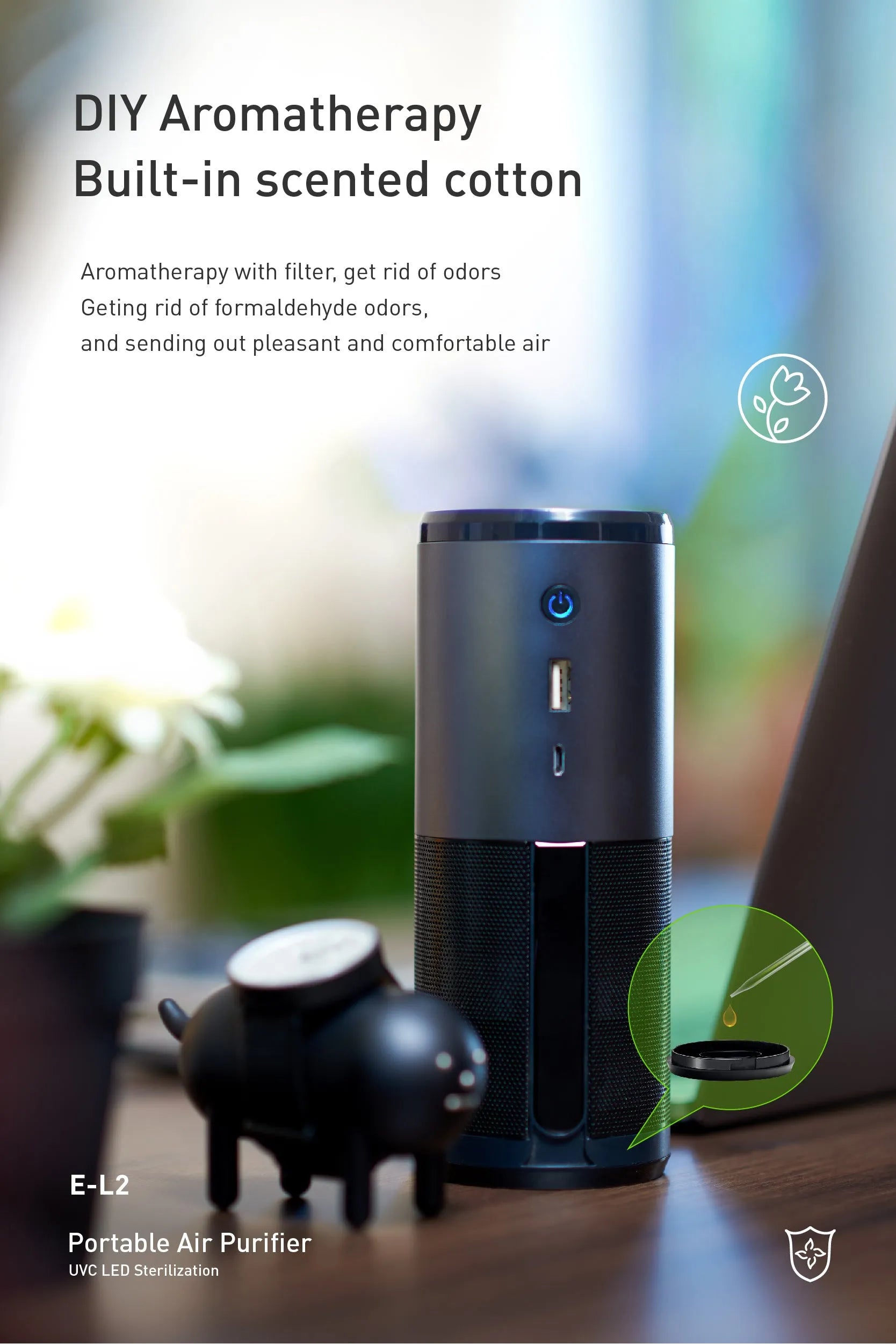 Black portable mini car air purifier with metal body and coloured light display on a desk