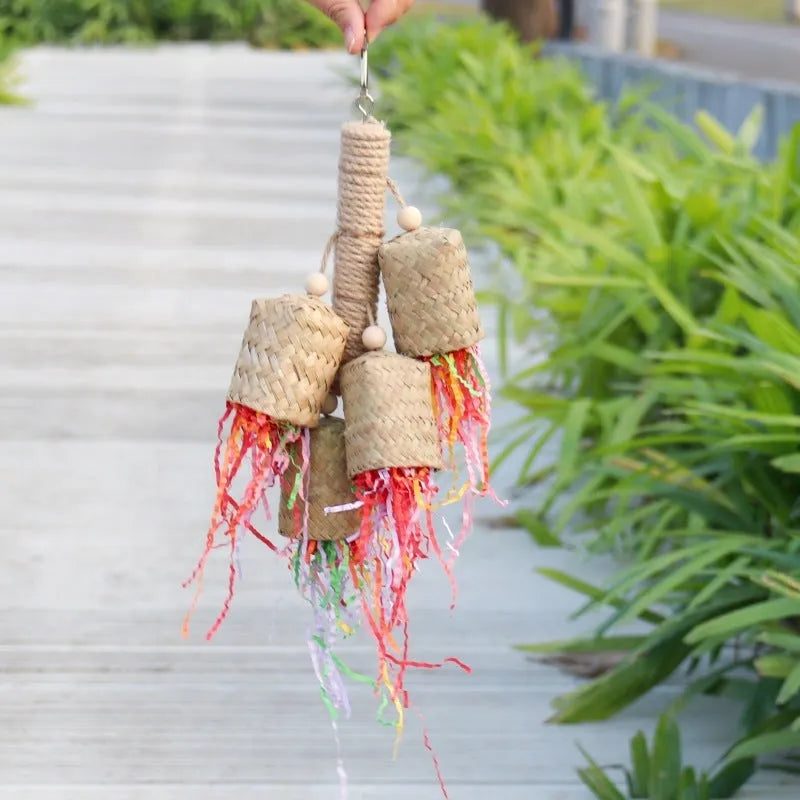 Colourful parrot chew toy with wood base, sisal rope and blue shredded paper attachments