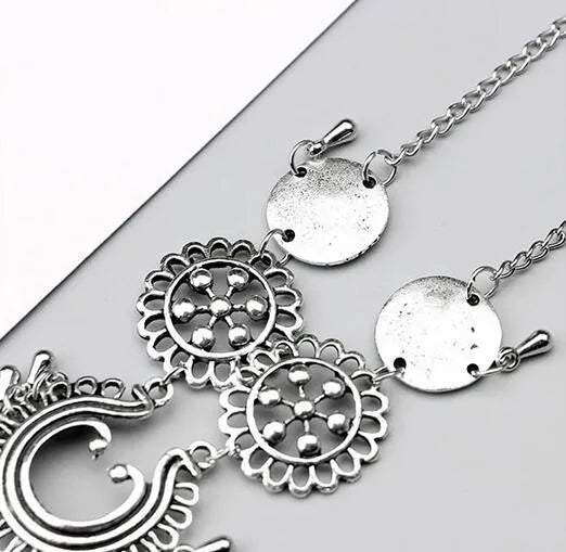 Antique silver hollow flower chain anklet with teardrop shape on a surface, 24cm foot jewellery for women