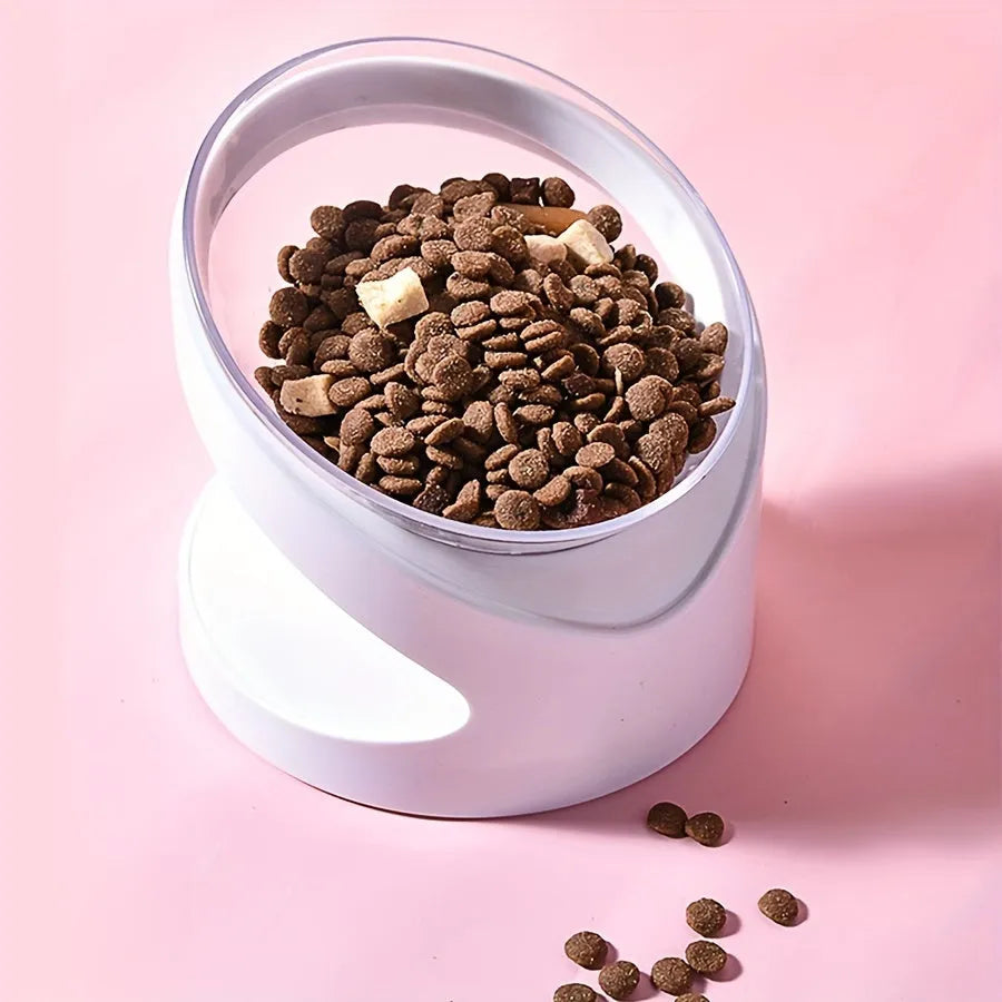 Clear plastic elevated cat food bowl with tilt design on white surface