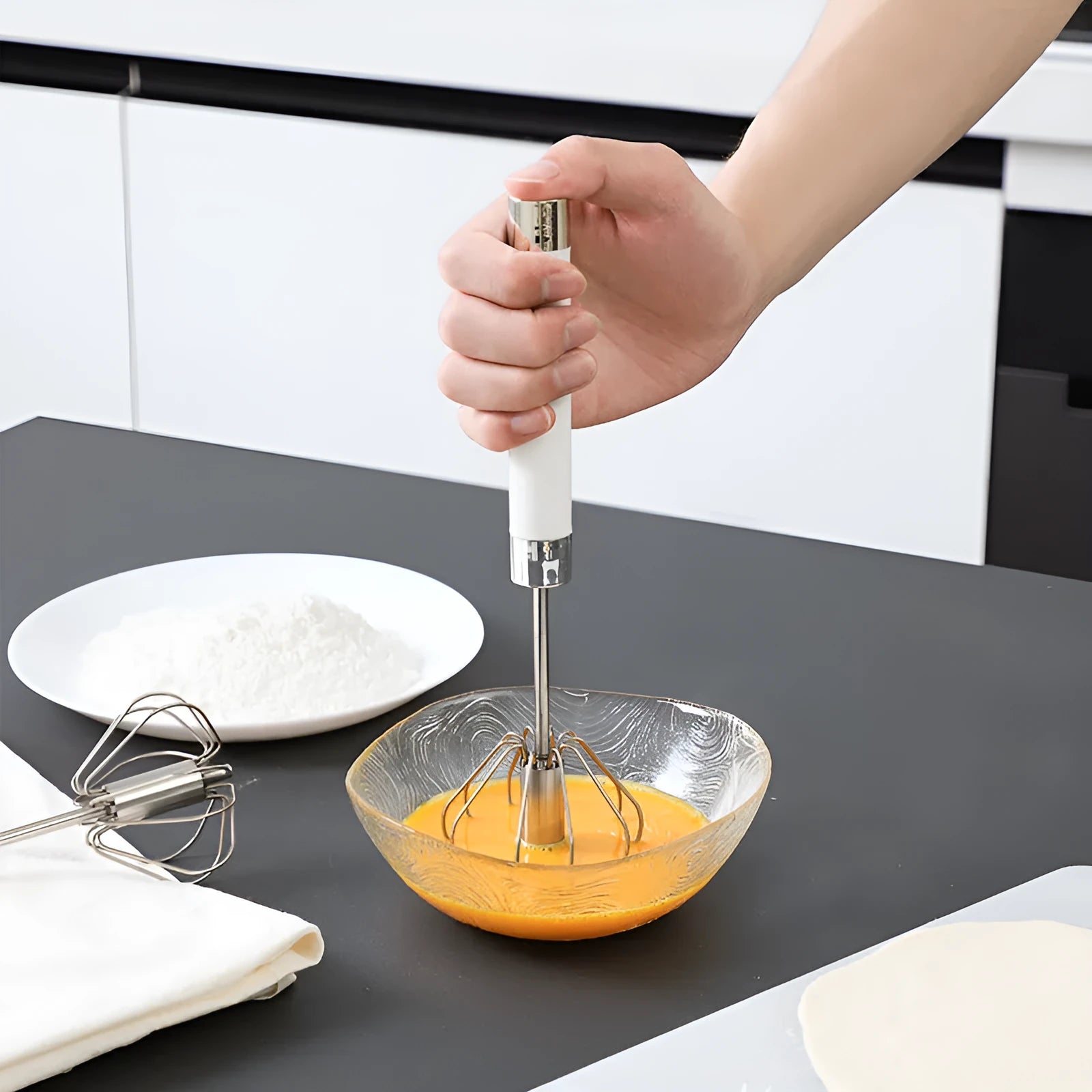 Semi-automatic manual egg beater whisk in stainless steel and white plastic
