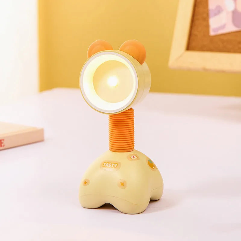 DIY cartoon animal small night lamp with magnetic base in assorted colours on a desk.