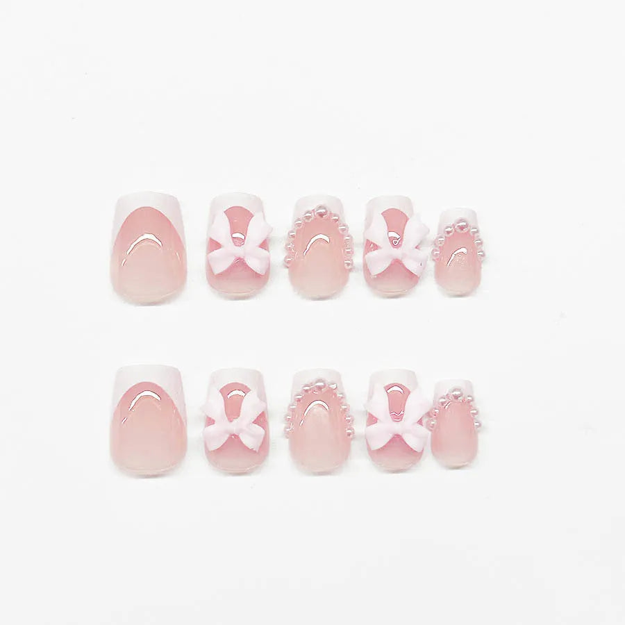 Short white French artificial nails with bow and tulip designs in European square shape