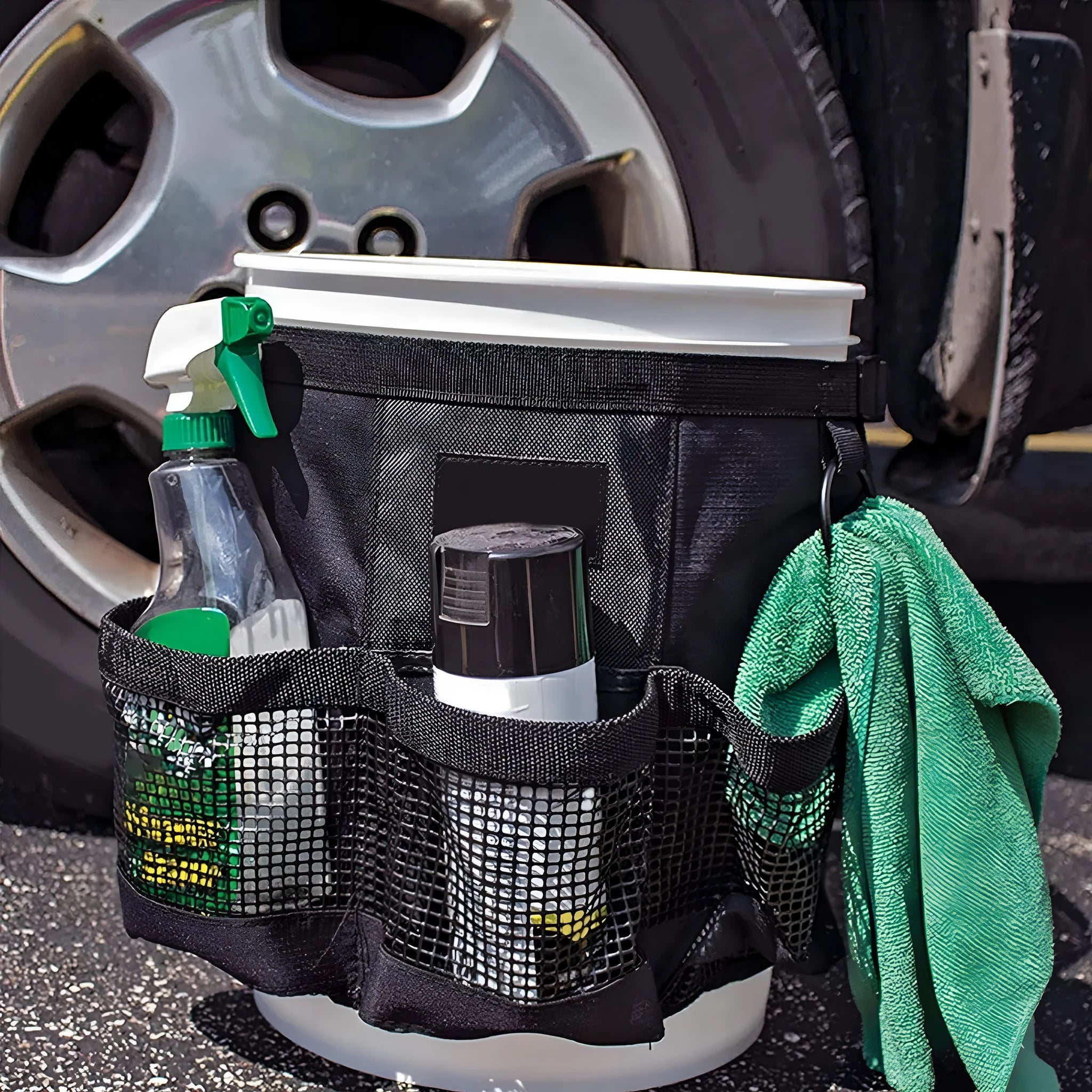 Black cylindrical polyester storage bag hanging on the side of a 5 gallon bucket.