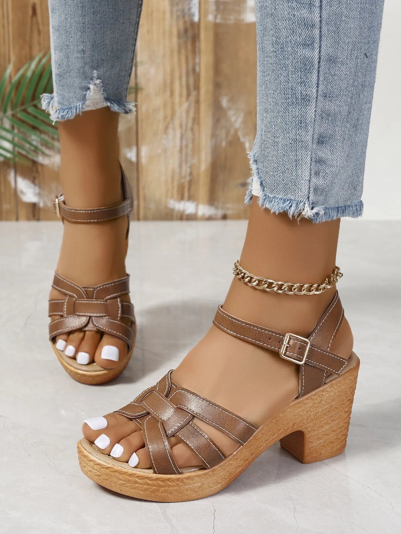 Plus size women's black peep toe sandals with a chunky heel and buckle ankle strap