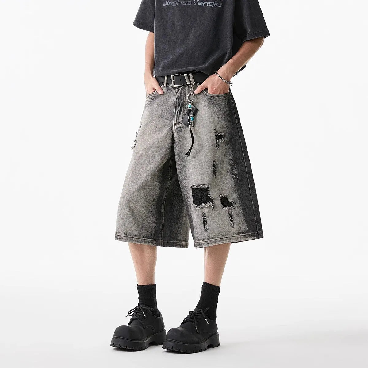 Grey water washed hole denim shorts with loose fit and cropped length on hanger
