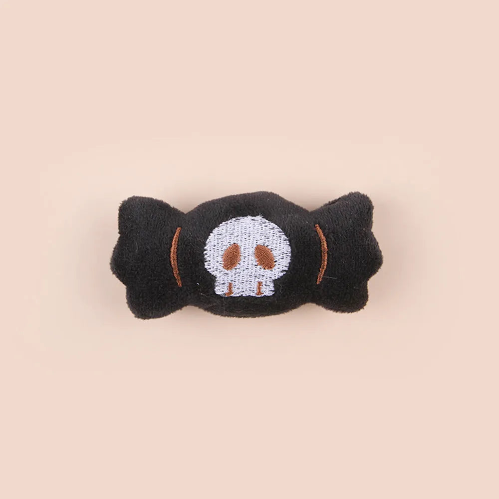 Small cat teaser wand with dangling plush candy, eye, and skull toy attachments