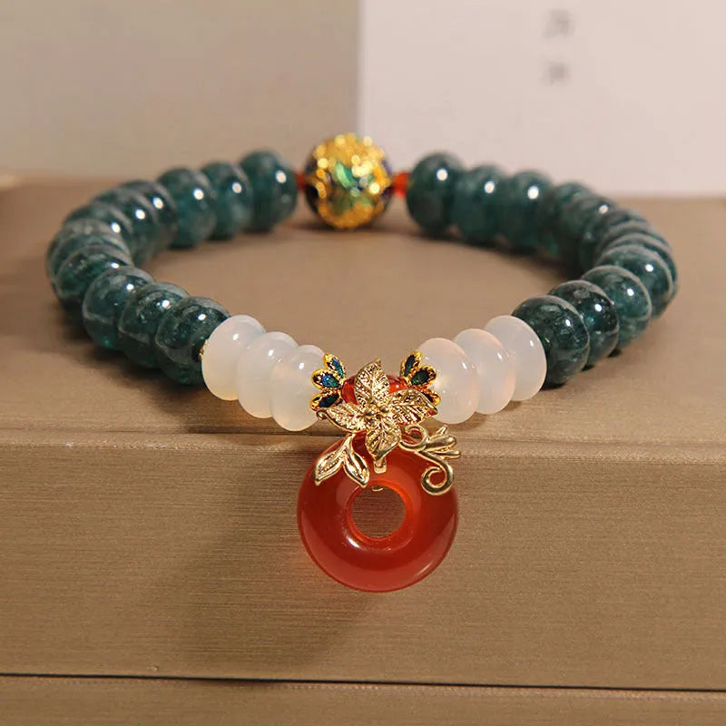 Blue water jade and red agate bracelet with peace buckle charm and rhinestone details