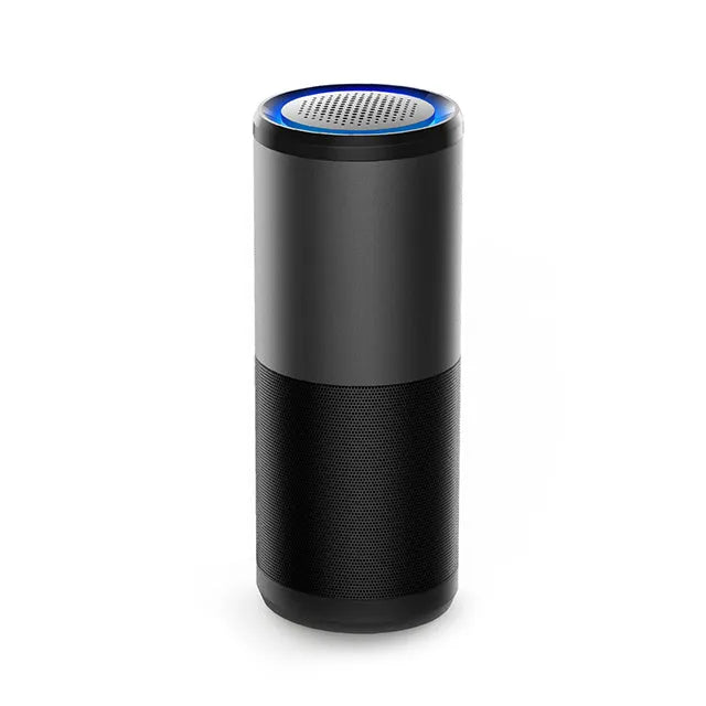 Black portable mini car air purifier with metal body and coloured light display on a desk