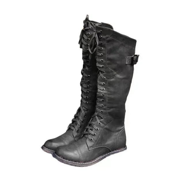 Women's black high leg boots with a round toe and low chunky heel on a plain background