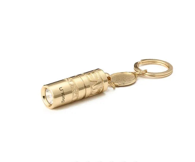 Gold zinc alloy waterproof mini LED flashlight on a keychain ring.