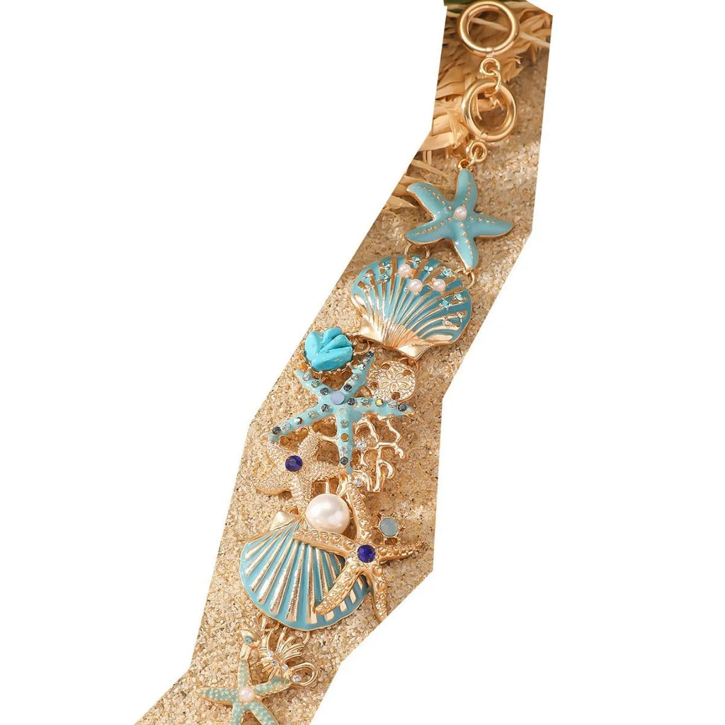 Women's alloy marine-themed bracelet with boat anchor, shells, starfish and rhinestones in turquoise, red or blue.