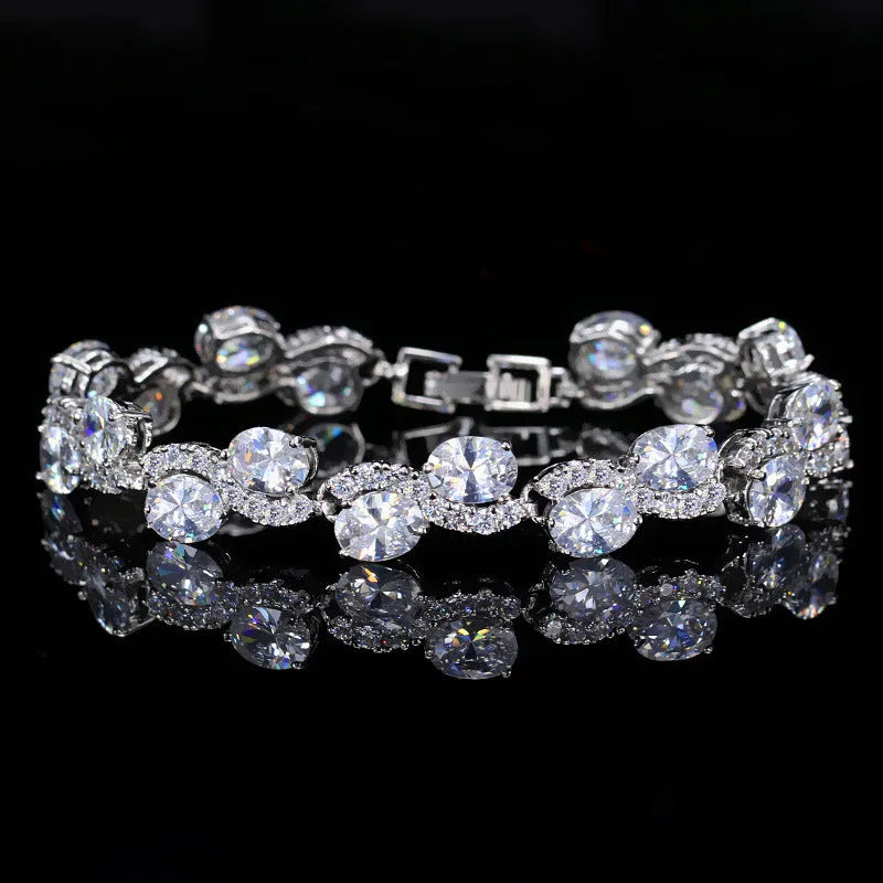18K copper electroplated gold bracelet with AAA+ zircon stones in a simple geometric shape on a wrist.