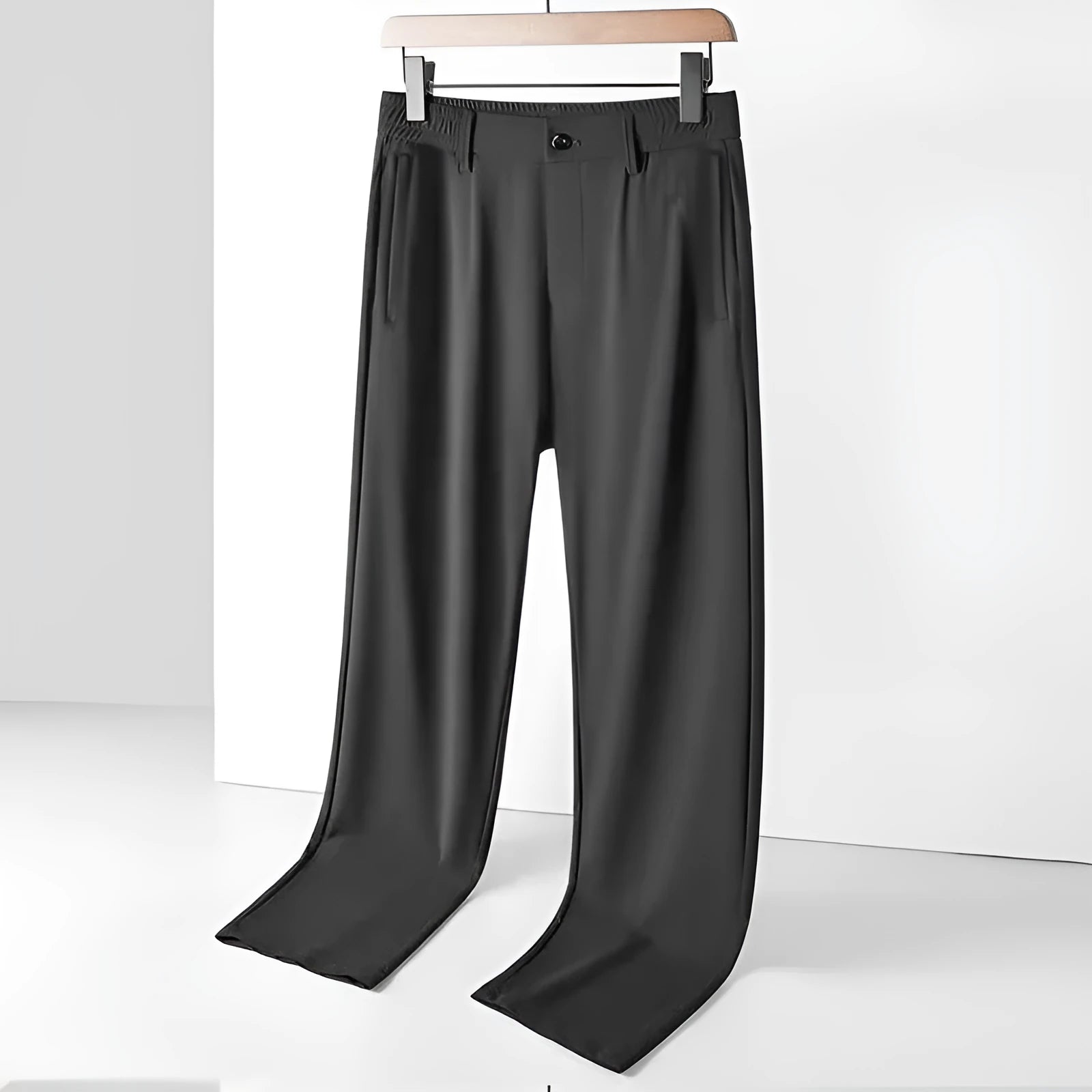 Man wearing black ice silk straight leg loose fit casual trousers with an elastic waistband