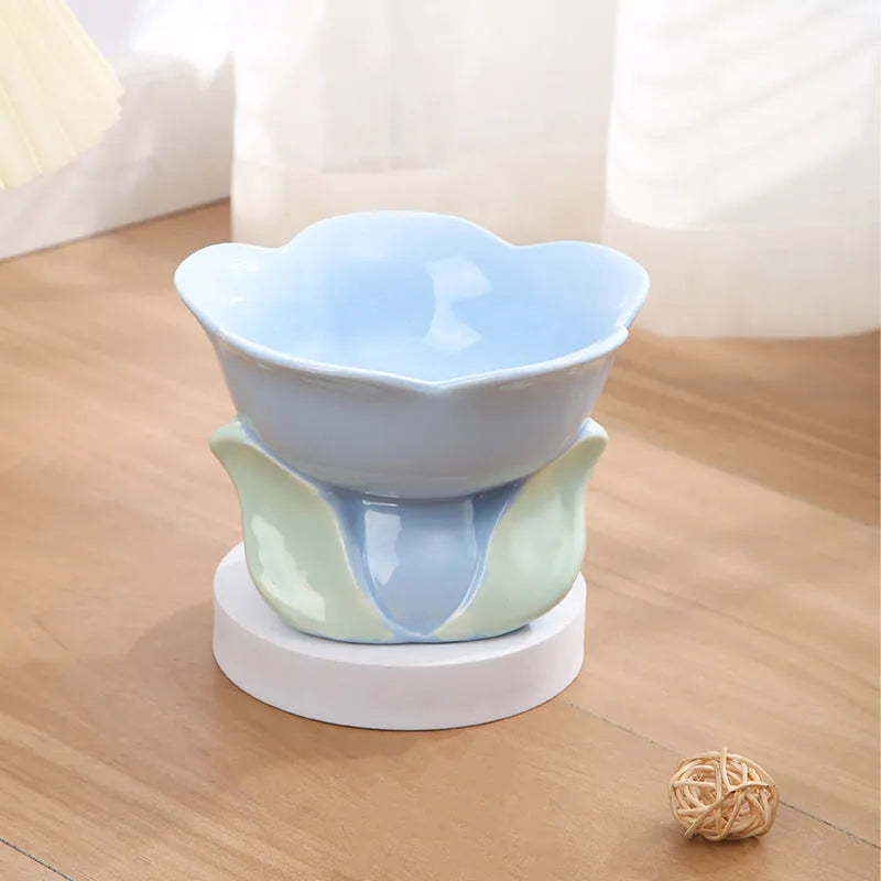 Pink floral patterned raised ceramic bowl for cat or small dog feeding on a non-slip base.