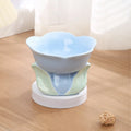 Pink floral patterned raised ceramic bowl for cat or small dog feeding on a non-slip base.