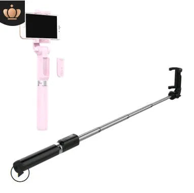 Aluminium Bluetooth selfie stick with tripod legs extended and wireless remote on a table