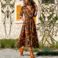 Women's printed chiffon V-neck dress with A-line skirt in black blue colour.
