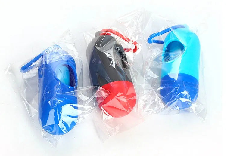Roll of multi-coloured dog waste bags showing black, blue, green, and pink examples