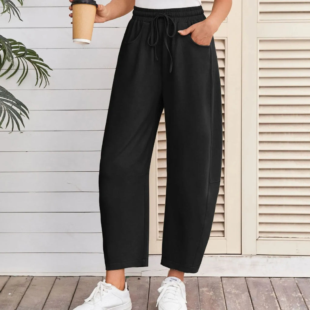 Women's loose cropped sweatpants with drawstring elastic waist and side pockets in street fashion style