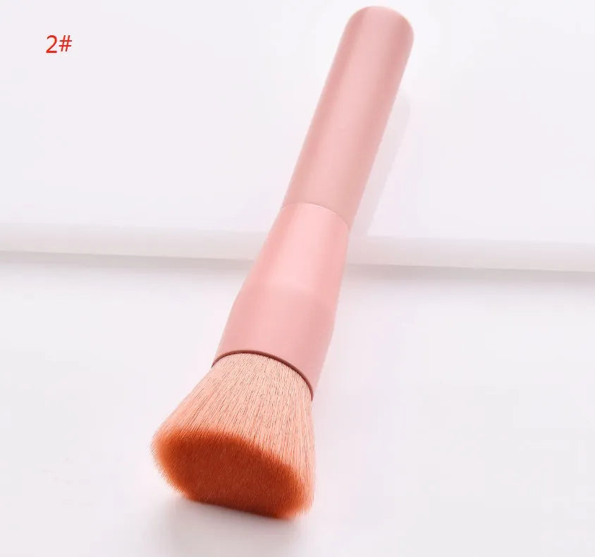Ten professional makeup brushes with wooden handles arranged by size for different cosmetic applications