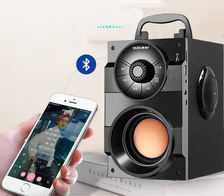 Black portable mini home audio system with subwoofer showing 3.5mm audio cable and USB power connection