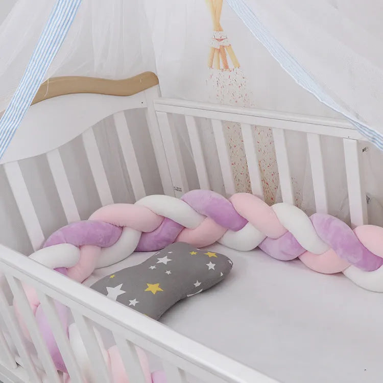 Multi-colour baby crib bumper made of spandex velvet, shown bent around a crib edge.