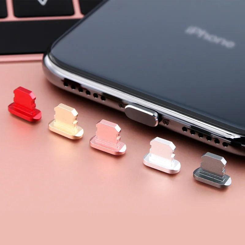 Aluminium alloy dust plug for iPhone charging port in various colours including gold, silver, blue, and rose gold.