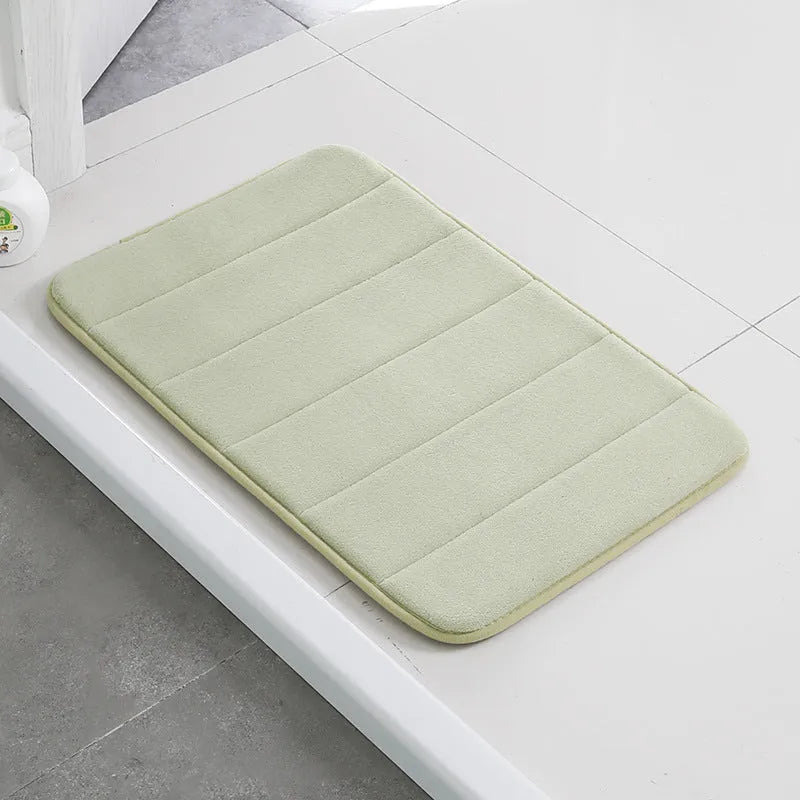 Coral fleece non-slip bath mat in 40x60cm size, placed on bathroom floor with water absorbent surface
