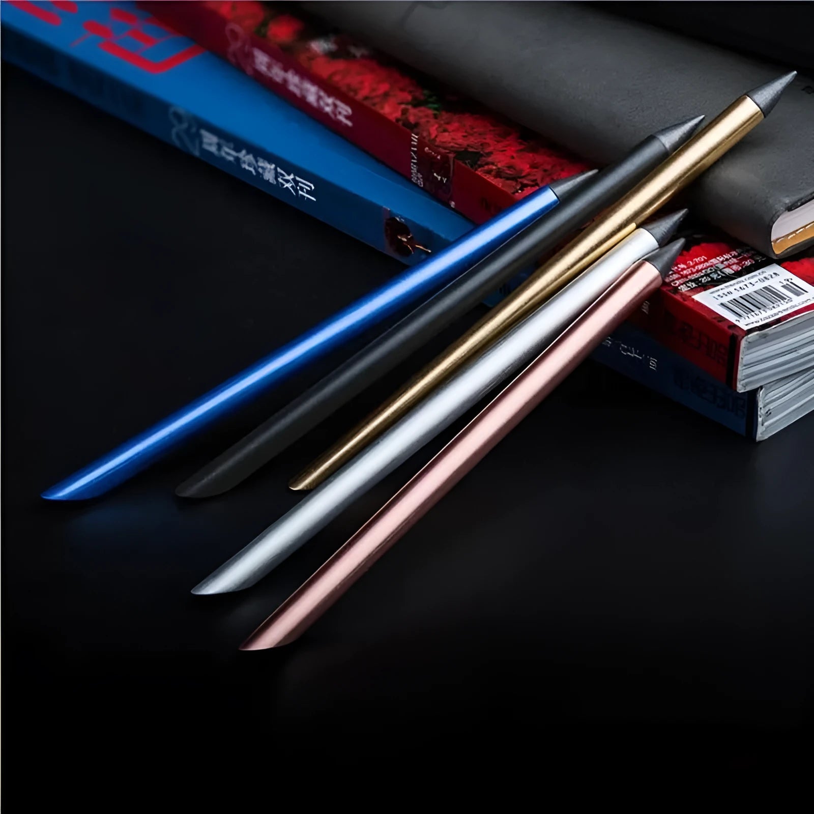 Silver inkless metal pen with alloy steel nib next to its presentation box and pen bag.