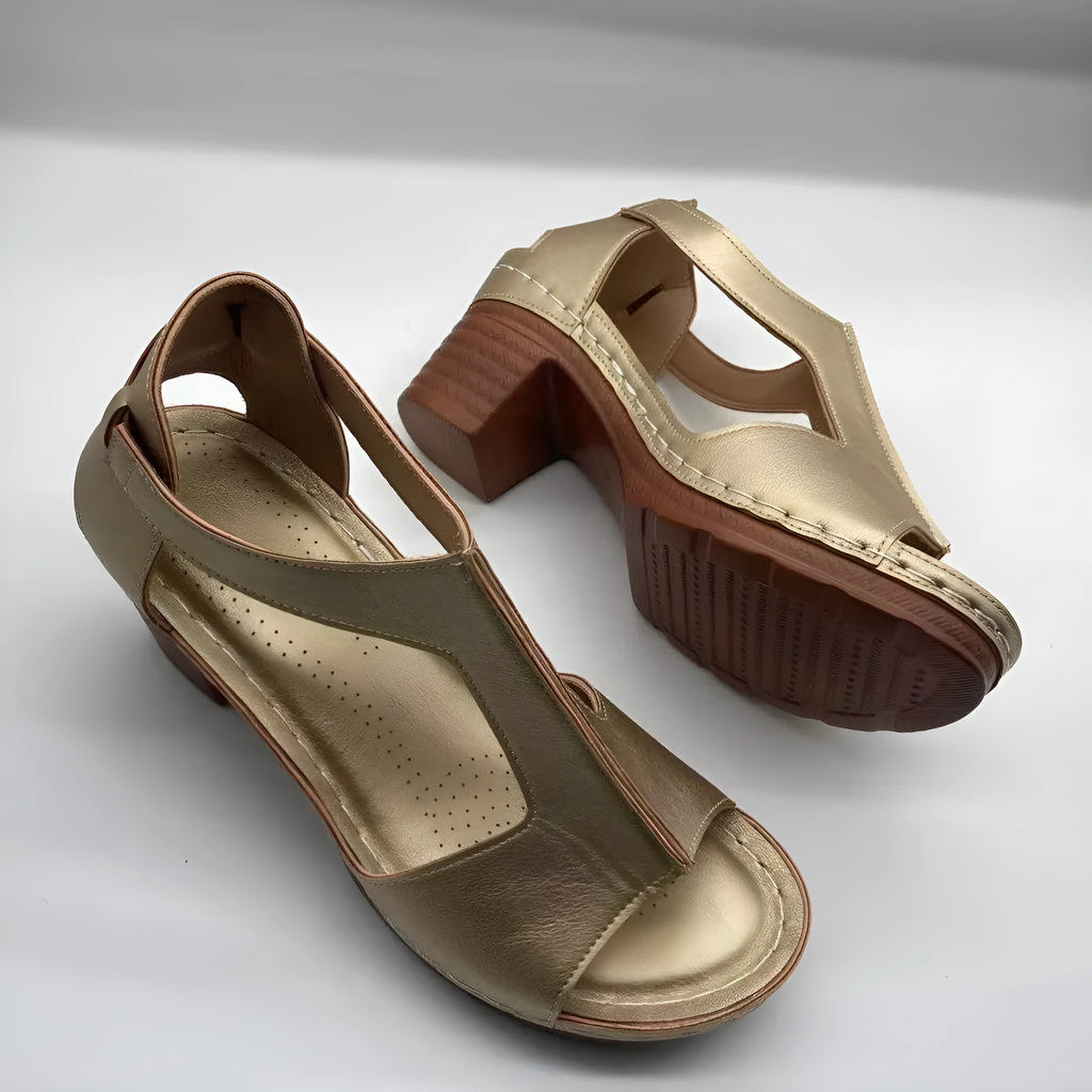 Women's white peep toe wedge sandals with a buckle strap on the ankle.