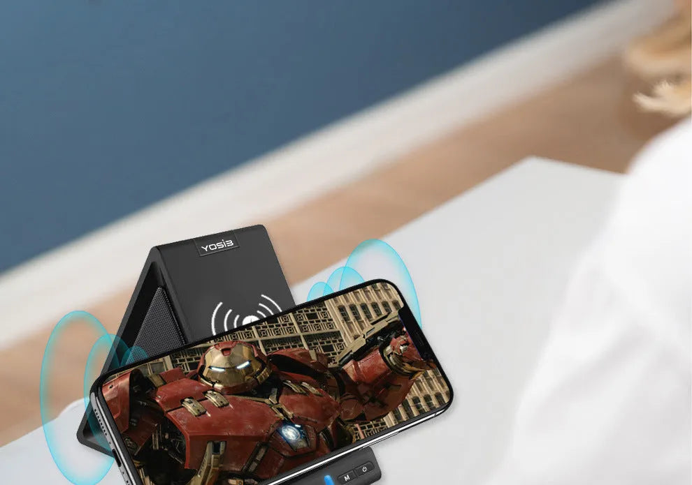 Black multifunctional Bluetooth speaker with integrated wireless charging base and phone stand.