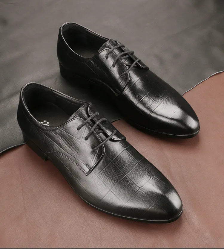 Men's black handcrafted leather derby shoes with a pointed toe and rubber sole.