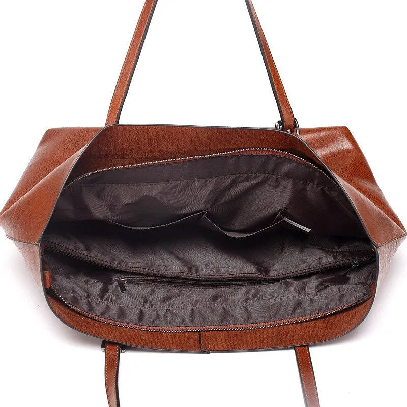 Brown waxed cowhide leather cross-body handbag showing two main compartments and a front mobile phone pocket.