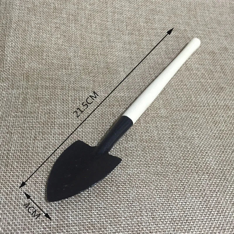 Succulent gardening tool set showing mini shovels, tweezers, watering can, brush and rake for small plant care