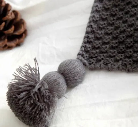 Nordic fringed knit ball acrylic blanket in beige colour on sofa