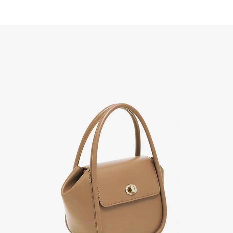 Women's leather wing tote bag with cross-body strap and latch closure in various colour options