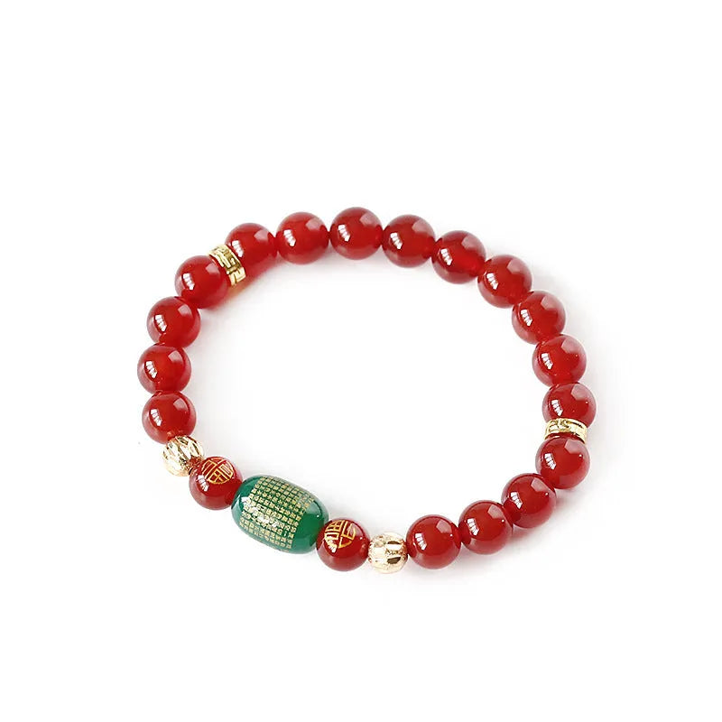 Agate Guanyin prayer bead bracelet in green or red on a wrist, showing auspicious patterns and charm.