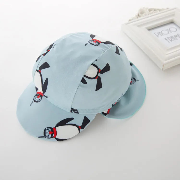 Boy's penguin print long sleeve swimsuit two-piece set with matching swimming cap