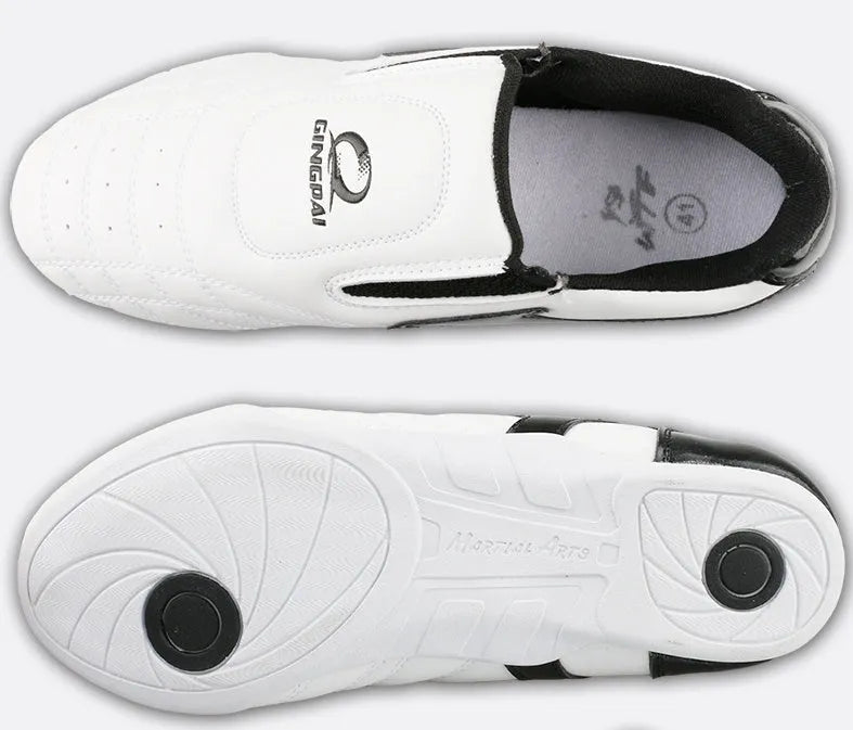 Black and white children's Sanda martial arts training shoes with a soft sole, shown with a shoe bag and socks.