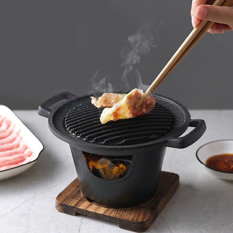 Mini BBQ grill alcohol stove with double-head flame and non-stick plate on tabletop