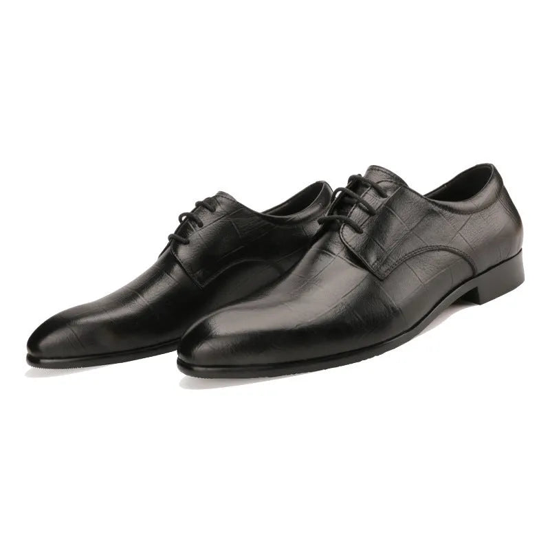 Men's black handcrafted leather derby shoes with a pointed toe and rubber sole.