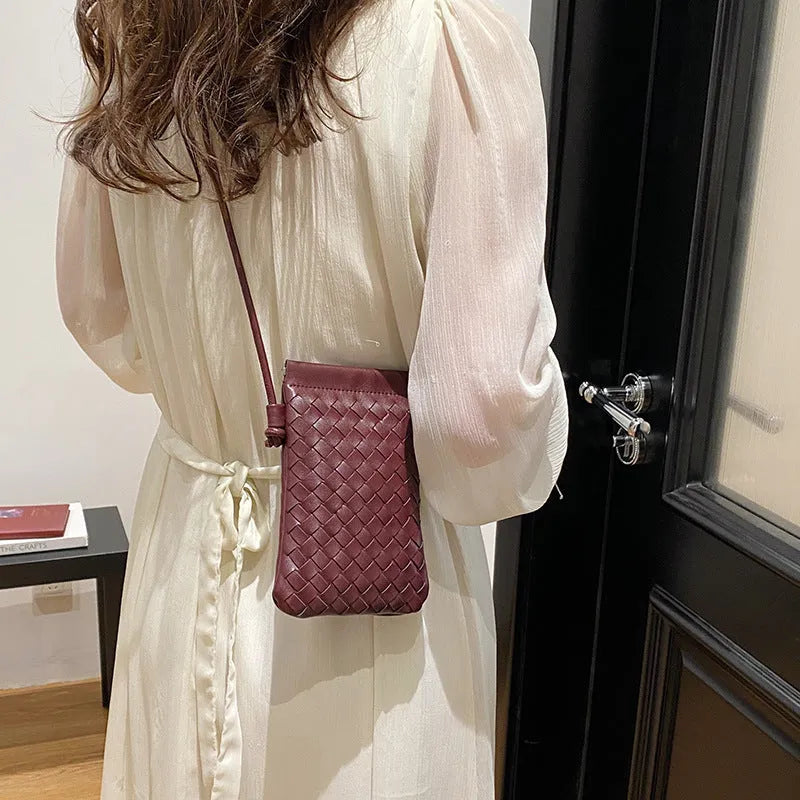 Vintage weave crossbody bag in retro style showing square vertical shape and woven texture