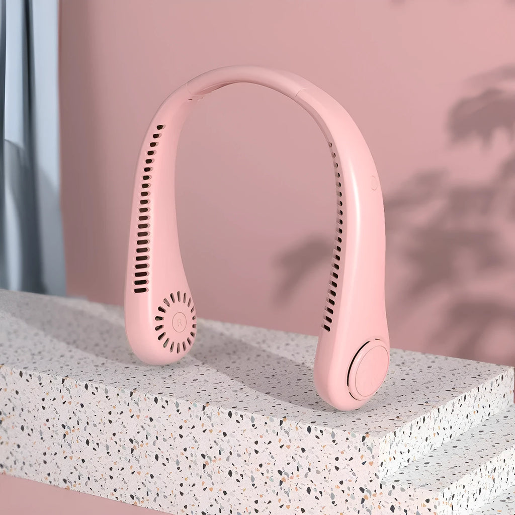 Pink portable bladeless neck fan hanging around a person's neck, showing the flexible design and air outlets.